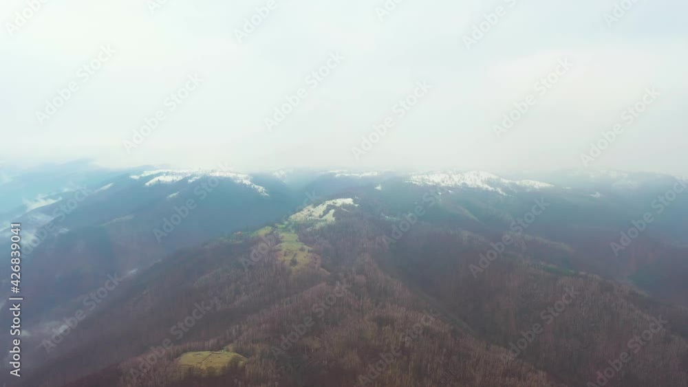 Aerial drone video of a mountain landscape in a cold foggy day Aerial drone video of a mountain landscape in a cold foggy day