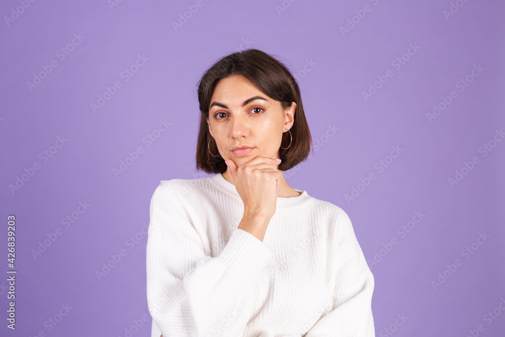 Young brunette in white casual sweater isolated on purple background thinking worried about a question, concerned and nervous Young brunette in white casual sweater isolated on purple background thinking worried about a question, concerned and nervous