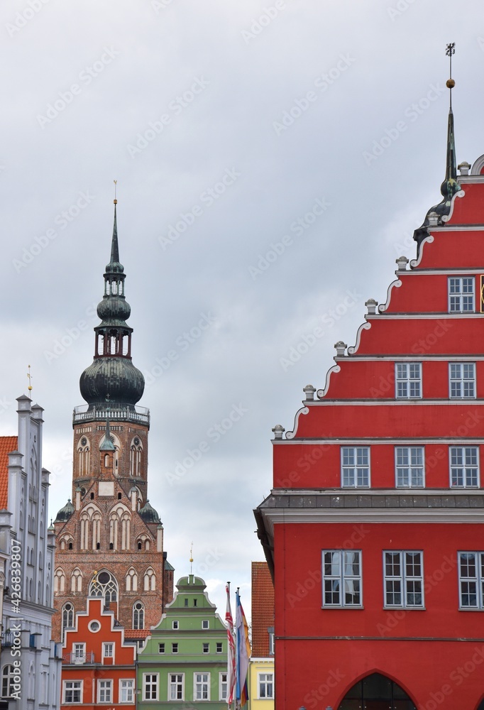 Colorful historical facades and cathedral at old market, Greifswald, Germany