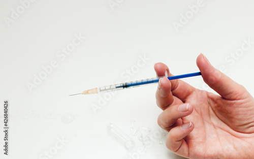 Fototapeta Naklejka Na Ścianę i Meble -  hand with syringe on white background