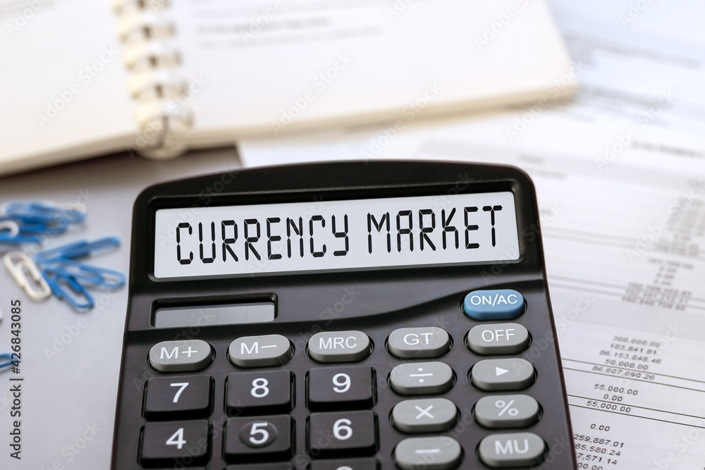 Calculator with the words currency market on the display Calculator with the words currency market on the display