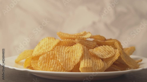 Potato chips yellow macro background. Unhealthy junk food closeup rotating.
