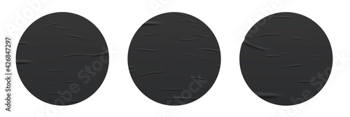 Glued round black stickers set isolated on white background. Vector realistic crumpled posters bundle. Wet greased wrinkles blank template texture. Empty advertising circles mockup for design