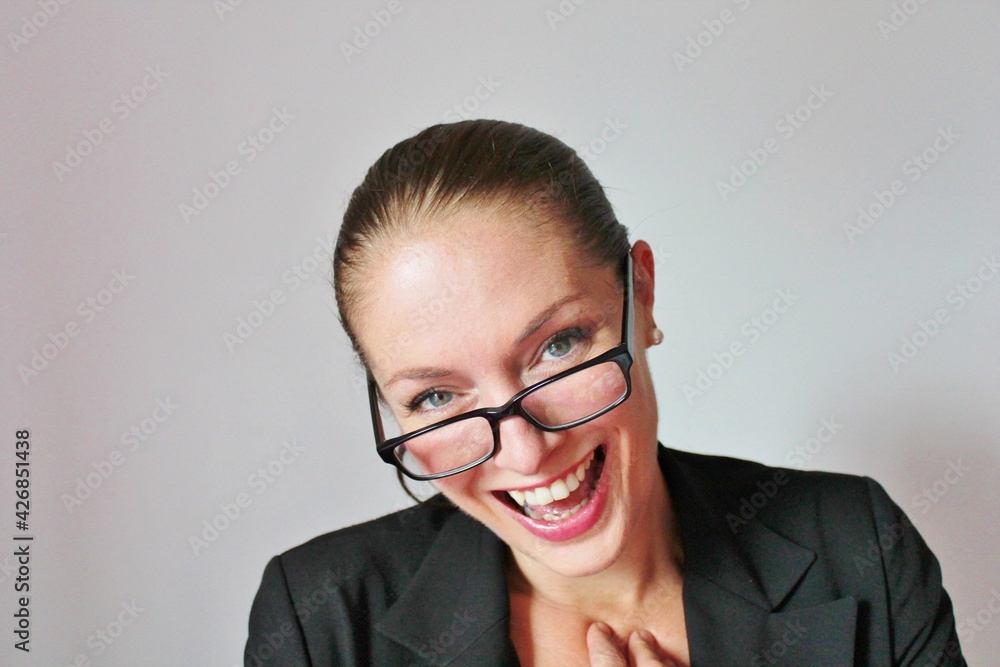 Attractive good looking Business woman in glasses laughing and smiling with copy space 