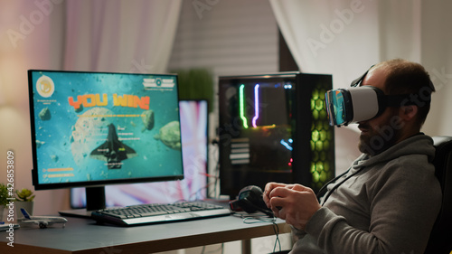 Pro cyber sport gamer wining playing video games using vr headset. Virtual space shooter game championship in cyberspace, esports player performing on powerful computer during gaming tournament