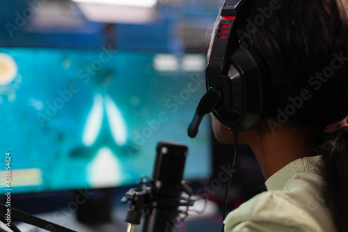 Close up of african online esport player streams live space shooter competition. Streaming viral video games for fun using headphones and keyboard for online championship.