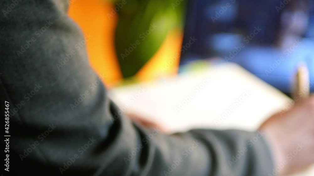 Blurry laptop with video conference. Woman in suite consulting online. Remote psychotherapy. Study from home Blurry laptop with video conference. Woman in suite consulting online. Remote psychotherapy. Study from home