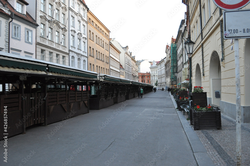 Prague, a deserted street with closed stalls and houses.