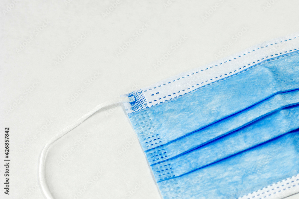 Medical mask against corona virus background mockup. Surgical protective mask closeup on white background. Medical mask against corona virus background mockup. Surgical protective mask closeup on white background.