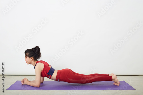 Active woman practicing yoga at home