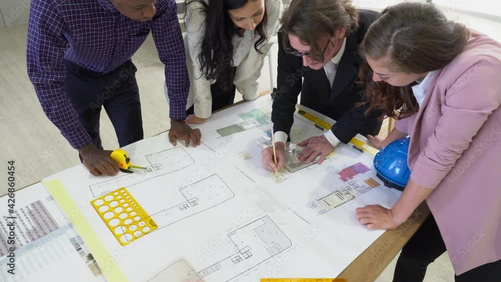 multiethnic engineer and architect team including caucasian and african people discuss about new building complex project in meeting. diversity in business workplace concept multiethnic engineer and architect team including caucasian and african people discuss about new building complex project in meeting. diversity in business workplace concept