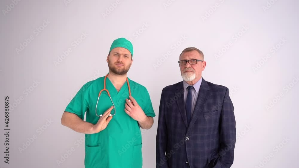 Labor Day. A young doctor with a phonendoscope and a mature businessman in a business suit are standing nearby. Cooperation of different professions Labor Day. A young doctor with a phonendoscope and a mature businessman in a business suit are standing nearby. Cooperation of different professions
