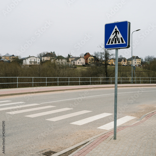 Pedestrian crosswalk across the road. Road signs and markings. Nobody.