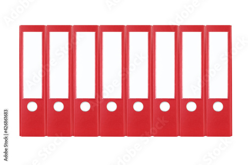 Reihe aus acht roten, breiten DIN A4 Aktenordnern bzw. Ordnerrücken, freigestellt / isoliert vor weißem Hintergrund