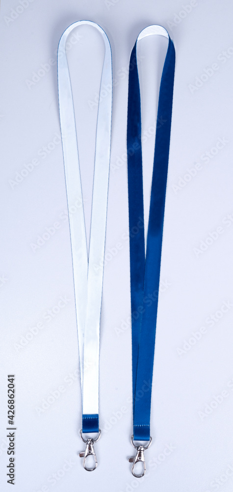 Blue and white Lanyards Neck Strap with Metal Lobster Clip . on white background. Up view. Blue and white Lanyards Neck Strap with Metal Lobster Clip . on white background. Up view.