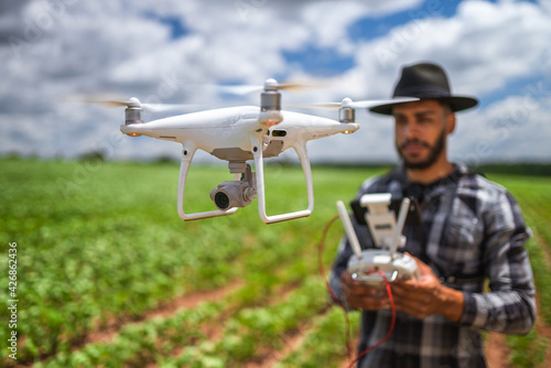 smart farming concept, latin american farmer using drone in field