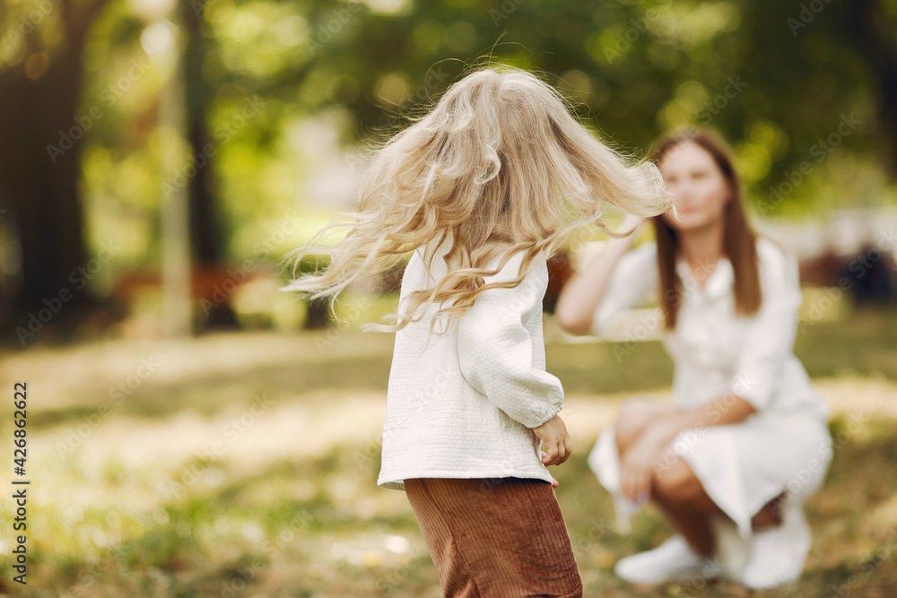 Mother with little daughter playing in a summer park Mother with little daughter playing in a summer park