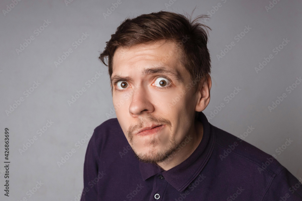 Obraz premium Emotions concept. Portrait of shocked male with small beard says wow, looks bugged eyes and rounded mouth, being amazed to see something unexpected. Terrified guy with surprised expression.