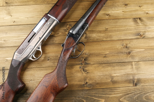 hunting rifles on a wooden background, top view with copy space. 