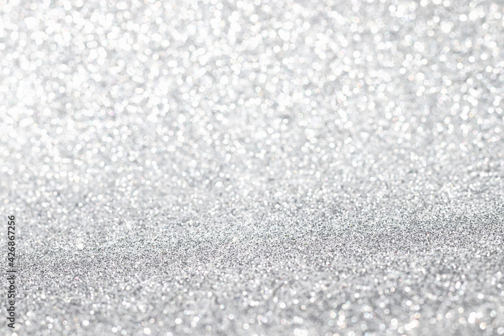 Obraz premium Shiny blurred white or gray background with bokeh for a festive mood. Greeting card template for fun.
