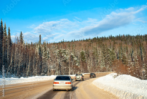 Winter track in the Siberian taiga on a sunny frosty day