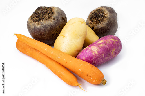 Beets, sweet potatoes, carrots and potatoes. Raw and whole, isolated on white background