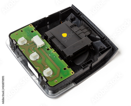 Plastic electronic control unit with black and blue connectors on a white isolated background in a photo studio. Spare part for sale or repair of car electronics in a car service.