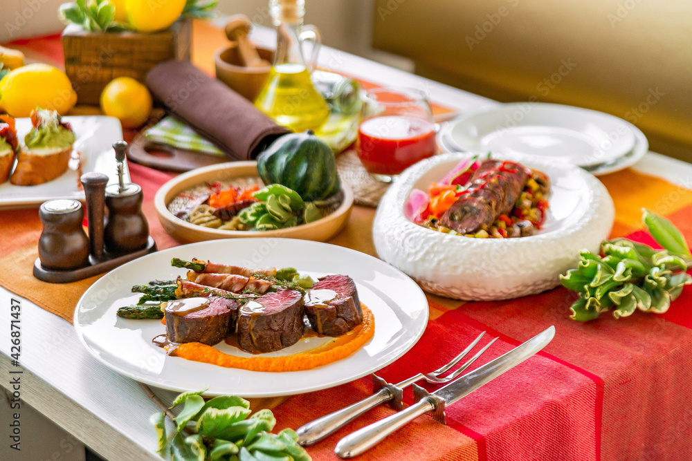 Served table in a restaurant with meat dishes