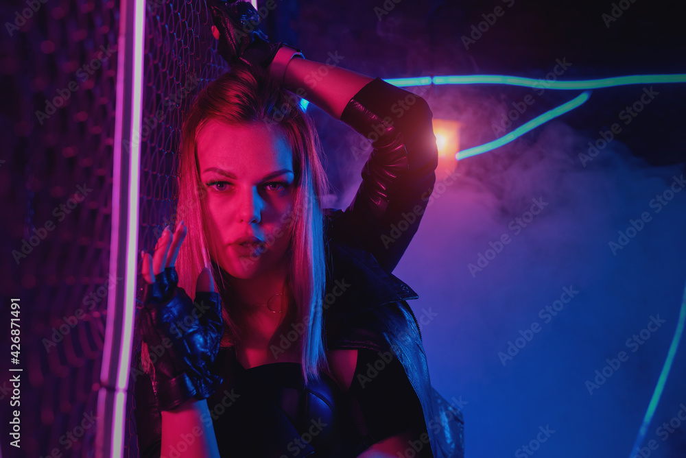 Young girl is posing in neon lights.