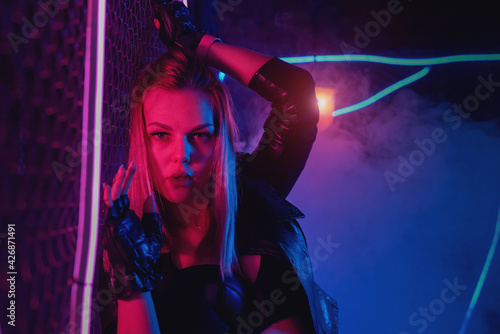Young girl is posing in neon lights.