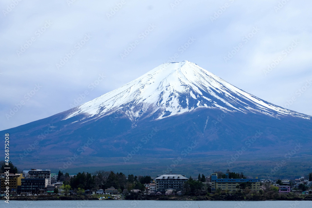 Close up Fuji Mountain in herizontal,against blue clods sky background ,cityscape view in front with lake Kawaguchiko in Japan. Close up Fuji Mountain in herizontal,against blue clods sky background ,cityscape view in front with lake Kawaguchiko in Japan.