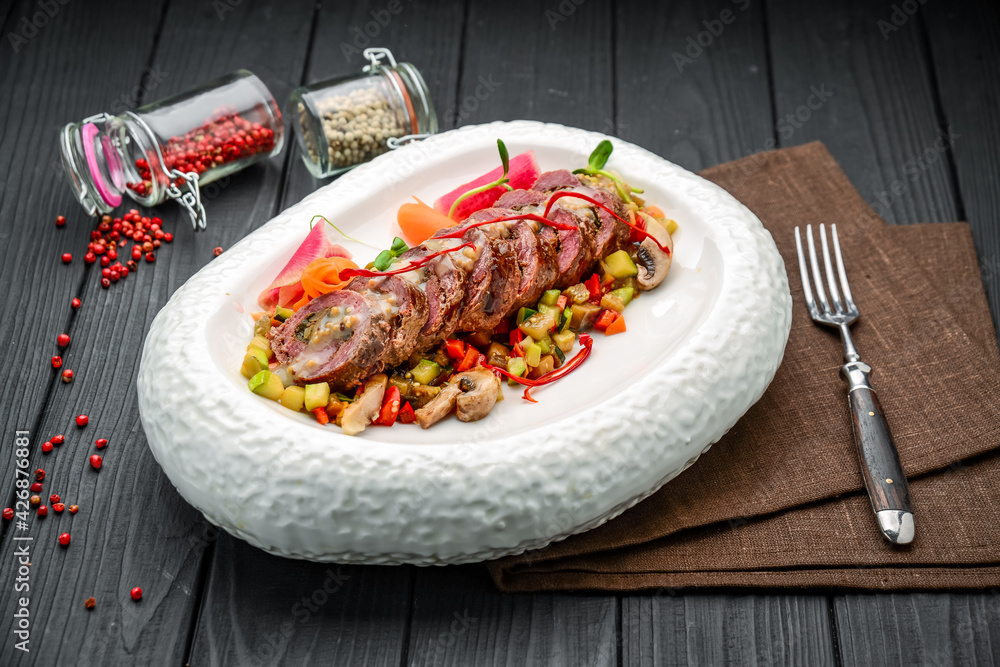 Veal roll stuffed with mushrooms with vegetable stew Veal roll stuffed with mushrooms with vegetable stew