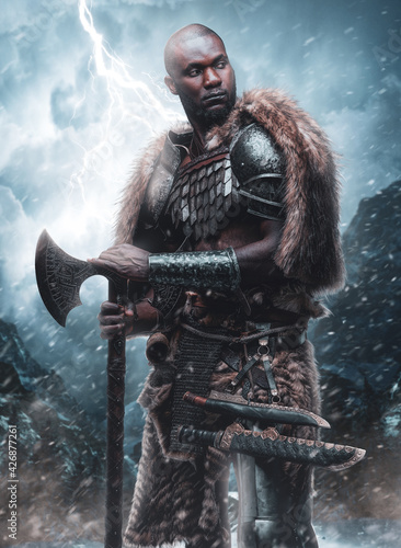 Antique african viking with axe and deerskin in stormy weather
