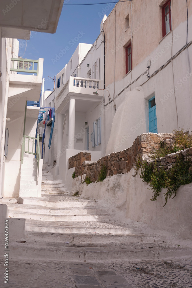 Obraz premium Empty cobbled streets, without people, whitewashed and white painted buildings in spring, in Mykonos town, Cyclades islands in the Aegean Sea. Charming place.