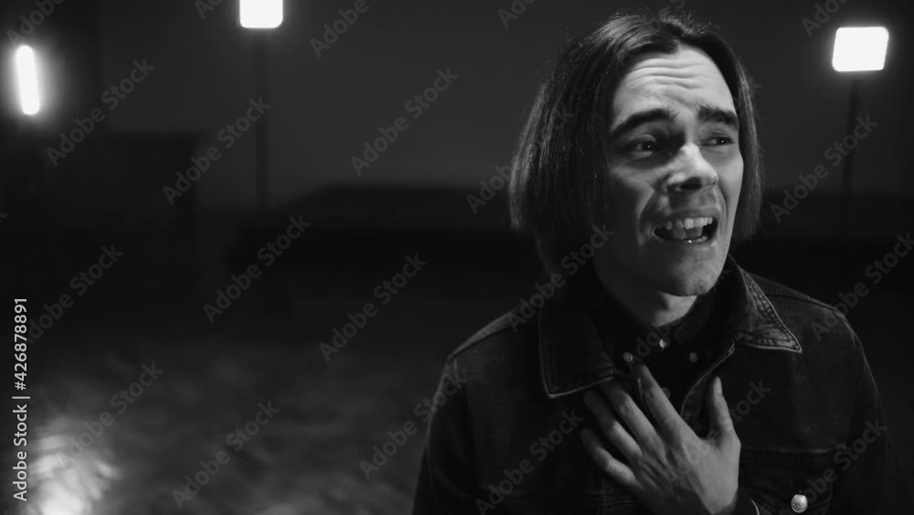 The singer is singing emotionally in the big hall. Black and white. BW. The singer is singing emotionally in the big hall. Black and white. BW.