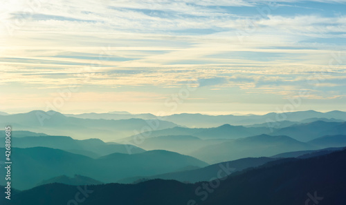 Layers of clouds and mountains that unite on the horizon. © yaro studio