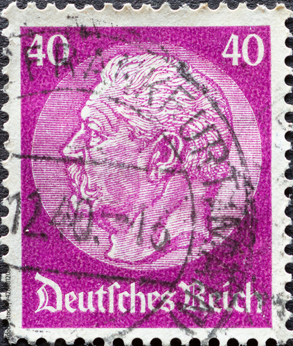 GERMANY - CIRCA 1933: a postage stamp from Germany, showing a portrait of the Reich President Paul von Hindenburg on a medallion. photo