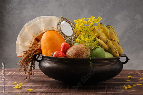 Kerala festival,rituals of Vishu festival -Vishukkani or Vishu sight, a brass vessel  filled with fruits,vegetable, paddy;mirror,golden shower flower and new cloth arranged  traditionally