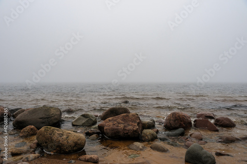 Rocks on the beach and misty morning