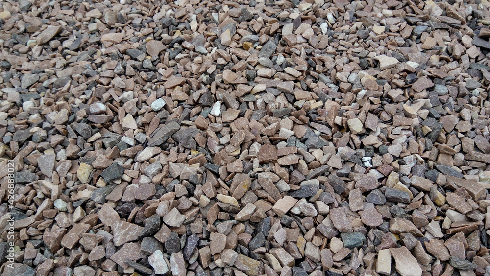 Close up of a lot of dried gravel stones. Scenic view of natural stone background. Industrial backdrop of modern build of the city road. Close up of a lot of dried gravel stones. Scenic view of natural stone background. Industrial backdrop of modern build of the city road.