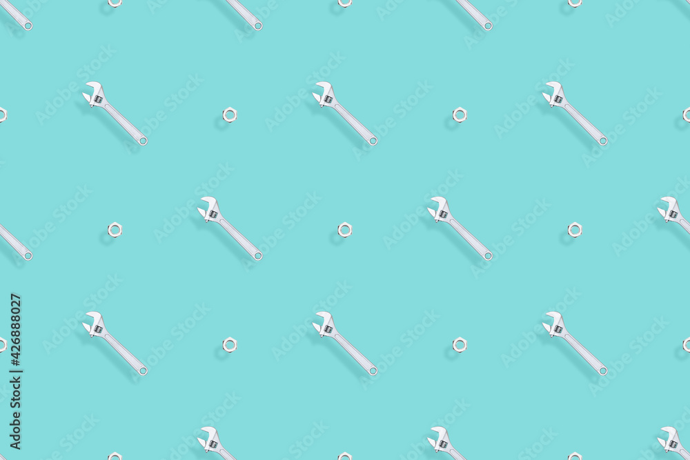 Adjustable metal wrench seamless pattern. Background from a metal wrench and nut. Adjustable metal wrench seamless pattern. Background from a metal wrench and nut.