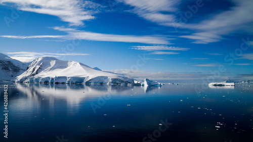 Snow covered Mountains and Icebergs in the Antarctic Peninsula on Antarctica. © Christopher