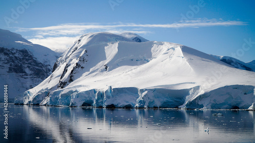 Snow covered Mountains and Icebergs in the Antarctic Peninsula on Antarctica. photo