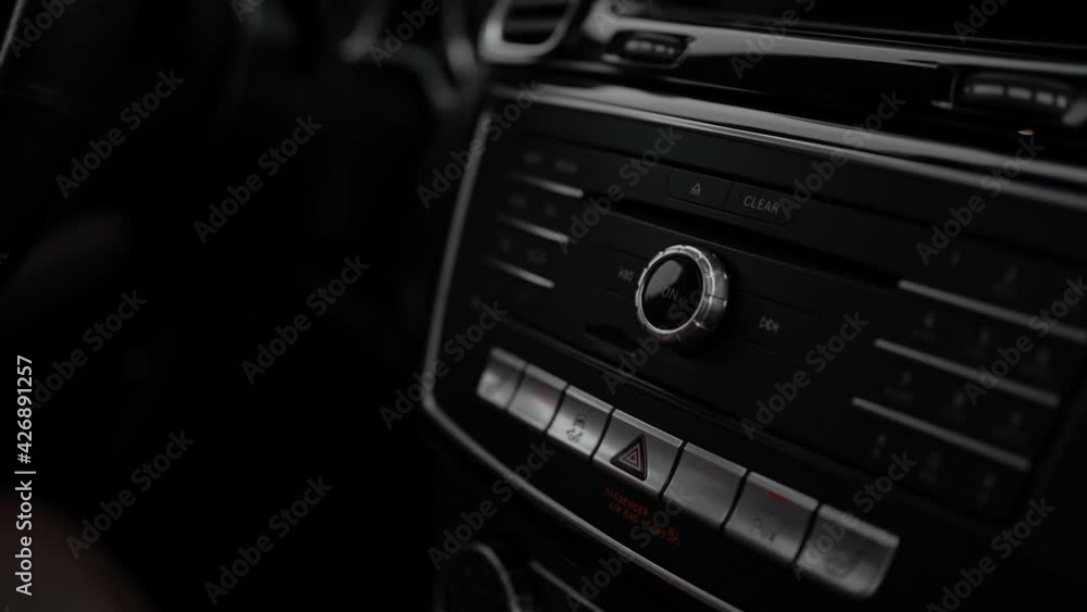 Multimedia control panel in the car. Black dashboard in automobile. Close-up, slow motion. Multimedia control panel in the car. Black dashboard in automobile. Close-up, slow motion.