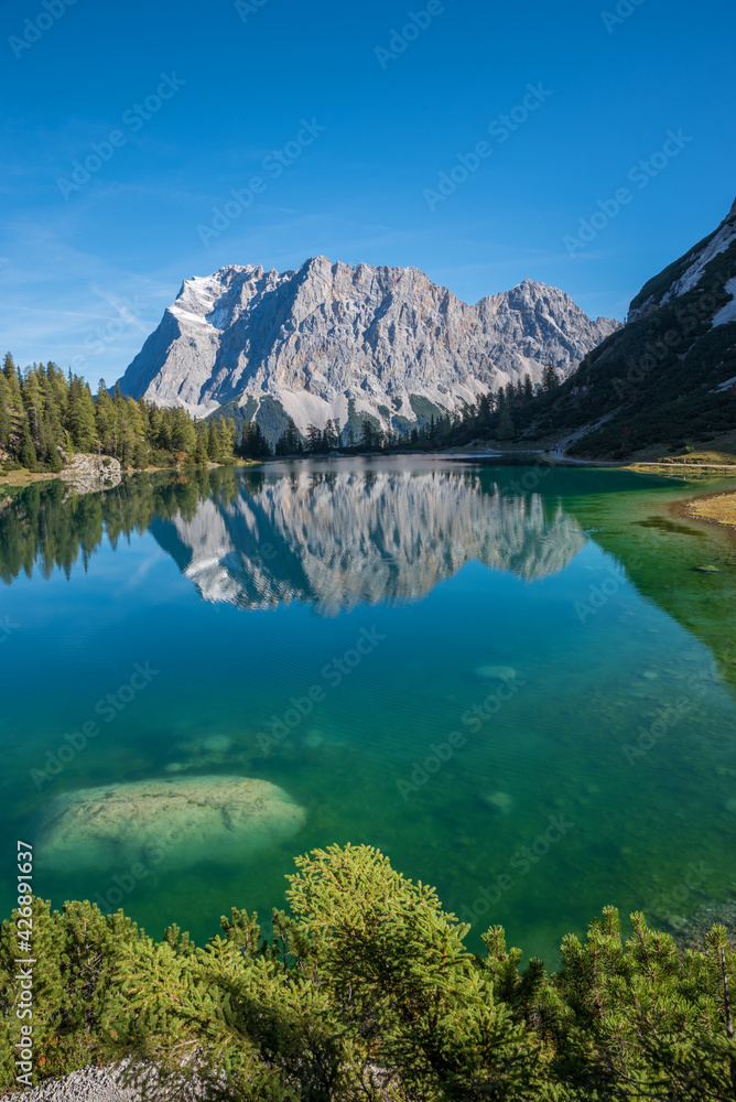 Zugspitze mountain reflecting in turquoise water of lake Seebensee ...