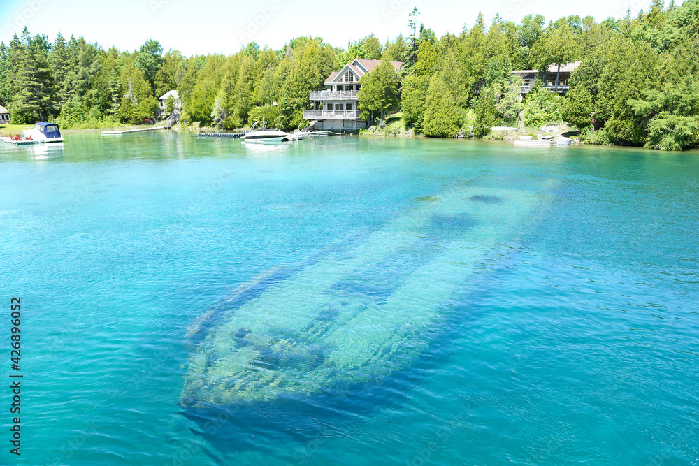 A sunk old wood boat under lake in landscape view