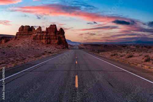 Middle of the Road View of a Scenic route in the desert. Colorful Sunrise Sky Art Render. Taken on Route 24, Utah, United States of America.