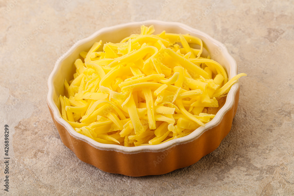 Shredded yellow cheese in the bowl Shredded yellow cheese in the bowl