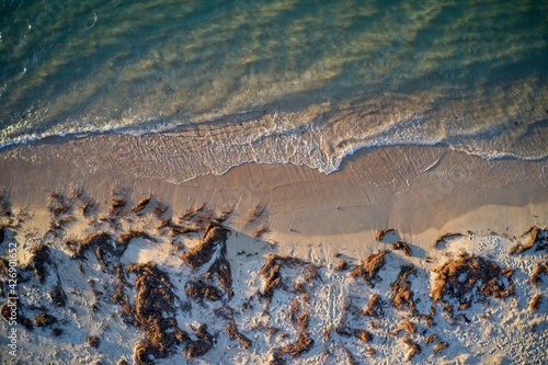 Drone field of view of water meeting beach in Mandurah, Western Australia.