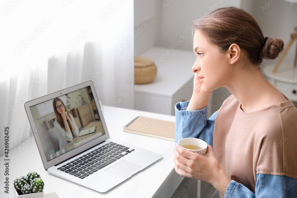 Stressed young woman asking psychologist for advice online at home Stressed young woman asking psychologist for advice online at home